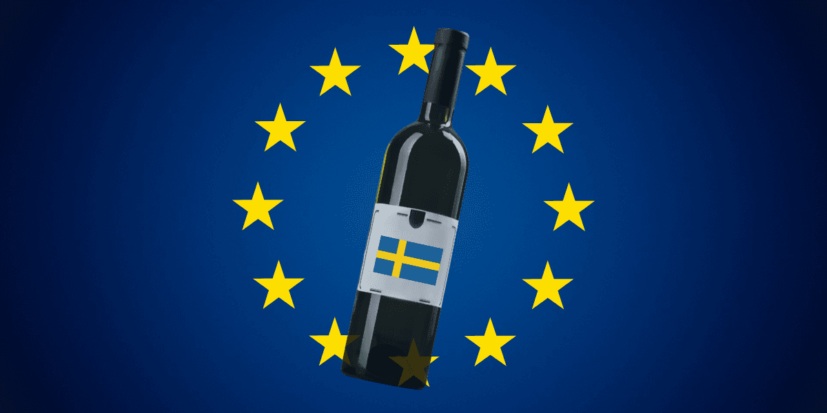 Vinflaska med svensk etikett över EU-flagga.